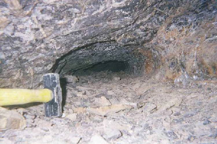 It is difficult get the exact feel of the Tomb, but the lowest point, near the back of the picture, is about 7 inches high. The width is about 20-24 inches. The hammer is a small 5 lb. sledge. Note the abundance of rock on the passage floor.
